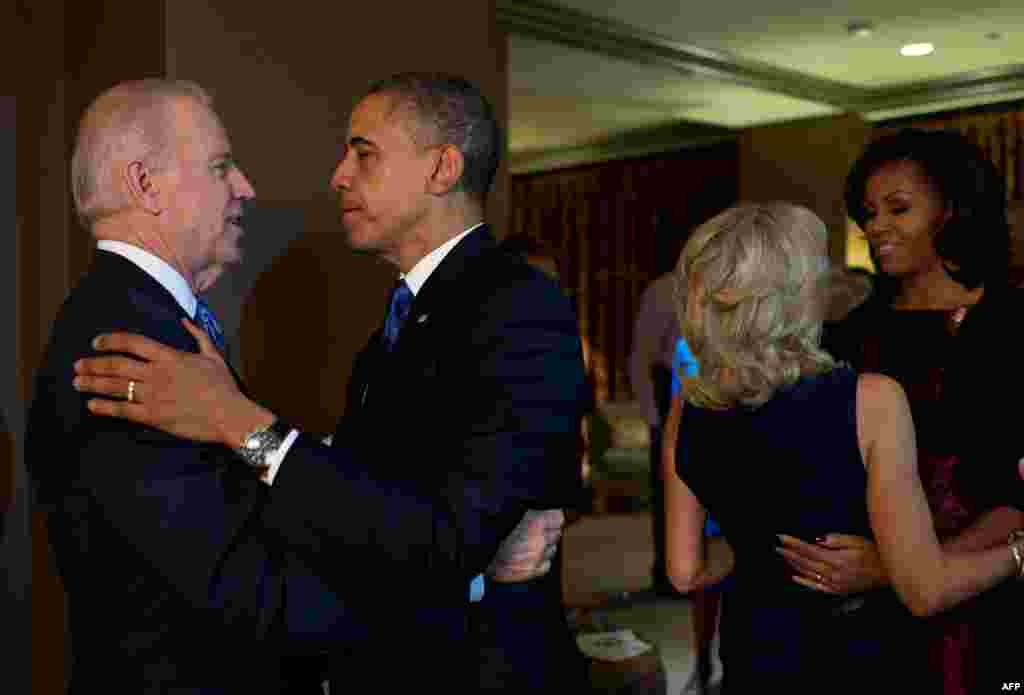 President Barack Obama and First Lady Michelle Obama embrace Vice President Joe Biden and Jill Biden in Chicago moments after the television networks called the election in their favor.