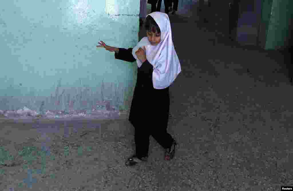 A blind student walks at the Kabul school.