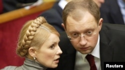 Then-Foreign Minister Arseniy Yatsenyuk chats with Yulia Tymoshenko in the Ukrainian parliament in Kyiv in 2007.