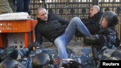 Riot police detained Left Front movement leader Sergei Udaltsov (top left) during a demonstration for fair elections in central Moscow on March 10.