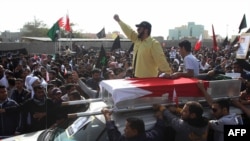 Protesters attend the funeral of Mahmud Mekki, who was killed during a raid on anti-regime protesters