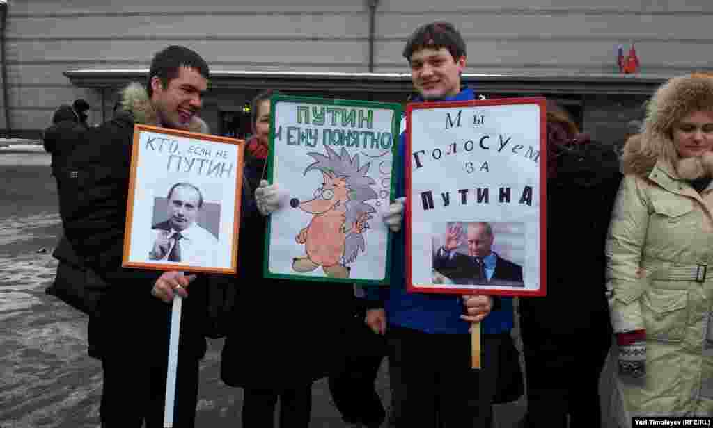 Marchers hold up their signs backing the prime minister&#39;s return to the presidency.