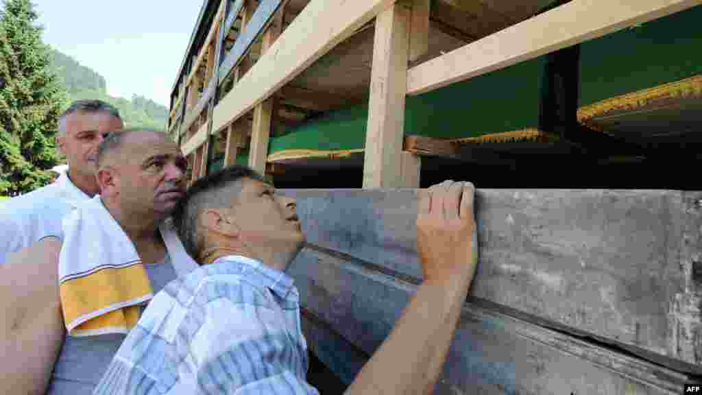 Muslims look for the names of relatives on a truck loaded with caskets during a farewell ceremony near the Visoko city morgue on July 9.