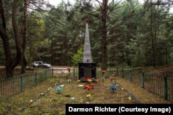 Novoshepelychi, Ukraine. An obelisk with the inscription: “Here were buried residents of neighboring villages who died at the hands of fascist invaders during the Great Patriotic War. 1941-1945.” The village of Novoshepelychi has largely disappeared into the forest after being heavily contaminated during the nuclear disaster, but the memorial appears to be well tended by former residents.