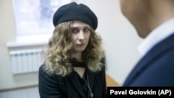 Russian activist Maria Alyokhina talks with her lawyer at a Moscow court on December 21.