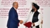 U.S. special envoy Zalmay Khalilzad (left) shakes hands with Taliban co-founder Mullah Abdul Ghani Baradar after signing the peace agreement during a ceremony in the Qatari capital, Doha, on February 29.