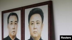 Portraits of North Korea's founder and former leader Kim Il Sung (left) and his son and current leader Kim Jong Il. No confirmed photos exist of Kim Jong Il's presumed successor, his son Kim Jong Un.