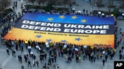 Activists unfurl a large banner in support of Ukraine outside the European Council building ahead of an EU summit in Brussels on March 5. 