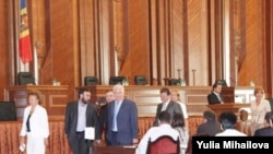 Moldovan President Vladimir Voronin (center) and fellow Communists walk out of a session of parliament on August 28.