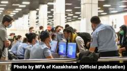 Ethnic Kazakhs arrive at Almaty airport from Kabul in September. 