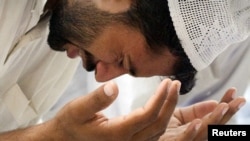 A man weeps while praying for victims at the Data Darbar Sufi shrine in Lahore, , where a double suicide attack in July killed 40 people and injured more than 200.