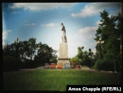 A children's train passes under a monument to Ukrainian poet Taras Shevchenko on Monastyrskiy Island, Dnipro.