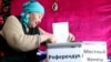 A woman casts her vote in the constitutional referendum in the village of Besh-Kungei, near Bishkek.