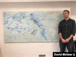 Evolutionary biologist Greger Larson flanks a whiteboard in his office at Oxford as he and his co-authors "turn it into a palimpsest" in November 2018 for their PNAS study. Human events are marked in blue and dog events in orange, with northeast Asia on the left and North America on the right. Co-author David Meltzer says it's "what scientific convergence sometimes looks like."