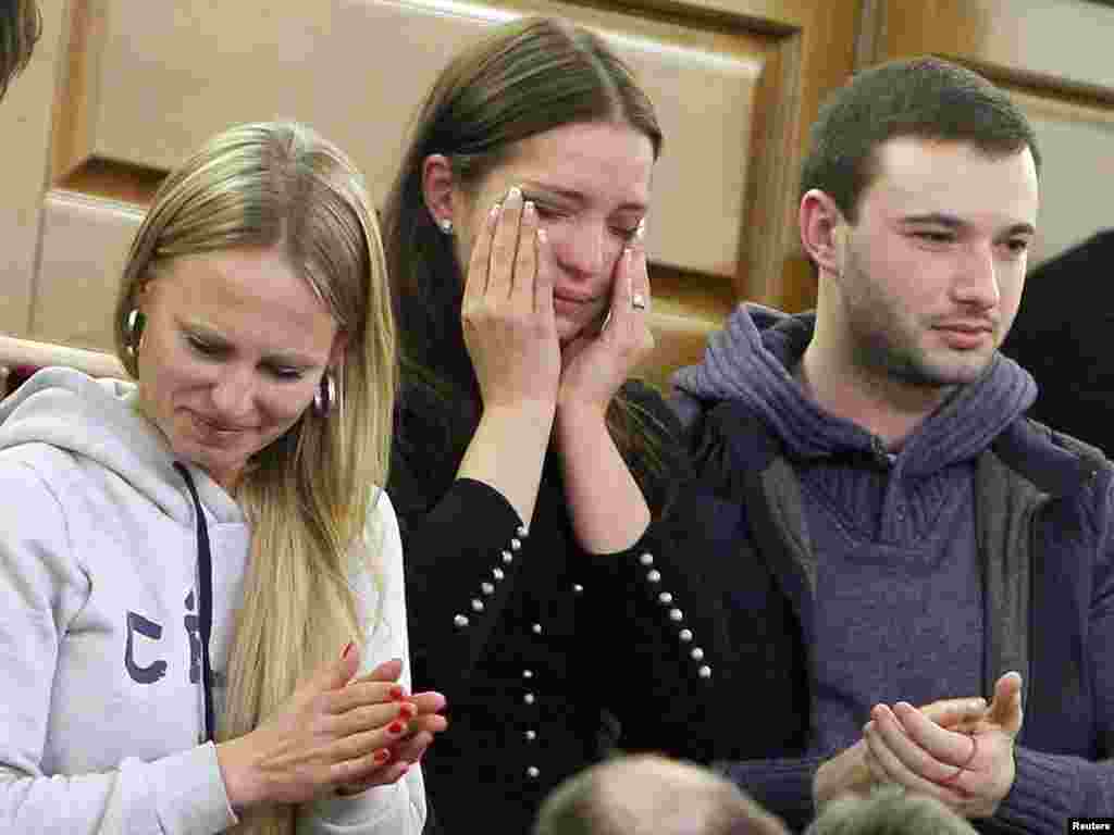 Yevhenia Tymoshenko brings her hands to her face as Ukraine's parliament voted to free her mother, Yulia Tymoshenko, on February 22, 2014.