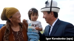 The leader of the Ak-Shumkar party, presidential candidate Temir Sariev (right), meets with local residents during his election campaign event in the village of Kun-tuu, near the capital of Bishkek, on September 11.