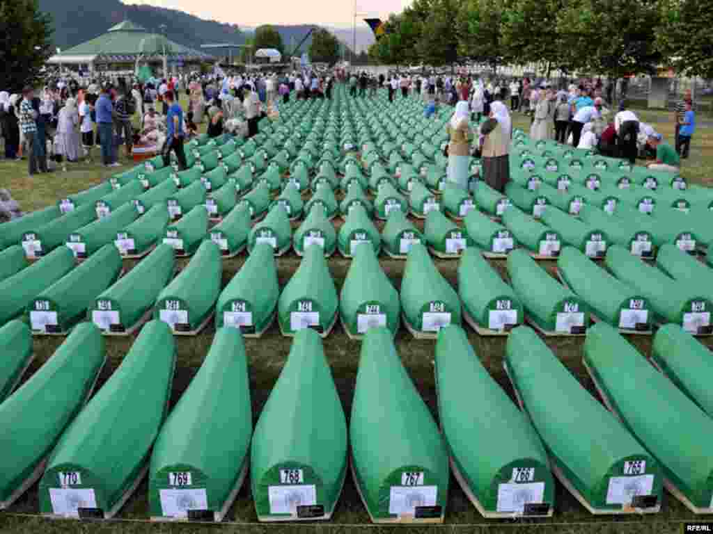 Coffins of newly identified victims during the preparations for the mass burial of another 775 victims.