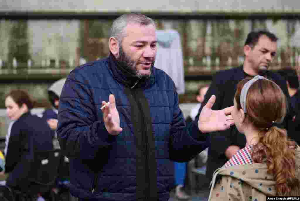 Zaza Saralidze, the father of one of the teens who was killed, speaks to well-wishers early on June 1 in Tbilisi.