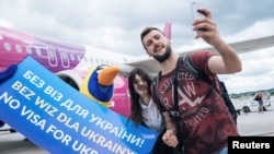 Passengers take selfies as they arrive from Kyiv after the European Union granted visa-free travel for Ukrainian citizens at the airport in Gdansk, Poland, in June 2017.