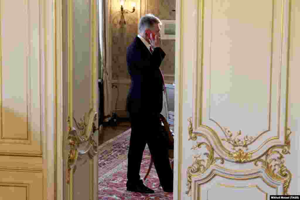 Kremlin spokesman Dmitry Peskov speaks on the phone inside the Villa La Grange.&nbsp;