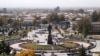 A massive statue of Tamerlane, seen in 2007, towers over UNESCO-protected medieval quarters of Shahrisabz, Uzbekistan before they were bulldozed in a government "tourism development" project.