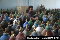 An Afghan man refills oxygen cylinders at a factory as demand skyrockets in Jalalabad on June 28.