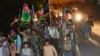 People wave the Afghan flag and chant slogans in support of the Afghan security forces fighting against the Taliban in Panjshir Province.