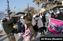 Taliban fighters fired into the air to disperse Afghan women protesting against restrictions in Kabul on December 28, 2021.