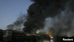 Pakistani firemen extinguish a fire on a burning oil tanker on a highway near Shikarpur, Pakistan, on October 1.