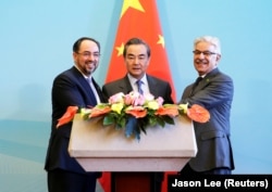 Afghan Foreign Minister Salahuddin Rabbani (left), Chinese Foreign Minister Wang Yi (center), and Pakistani Foreign Minister Khawaja Asif attend a joint news conference after the first China-Afghanistan-Pakistan Foreign Ministers' Dialogue in Beijing in 2017.