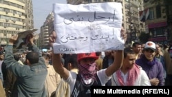 A young protester during the antigovernment demonstrations in Cairo's Tahrir Square in February 2011: "Enough already, my arms hurt!"