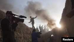 A cameramen at the filming of an Afghan feature film in the village of Sarai Khuja, north of Kabul, in June 2011.