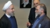 An undated photo issued by IRNA on December 1 shows Iranian President Hassan Rohani (left) awarding nuclear scientist Mohsen Fakhrizadeh a medal in Tehran.