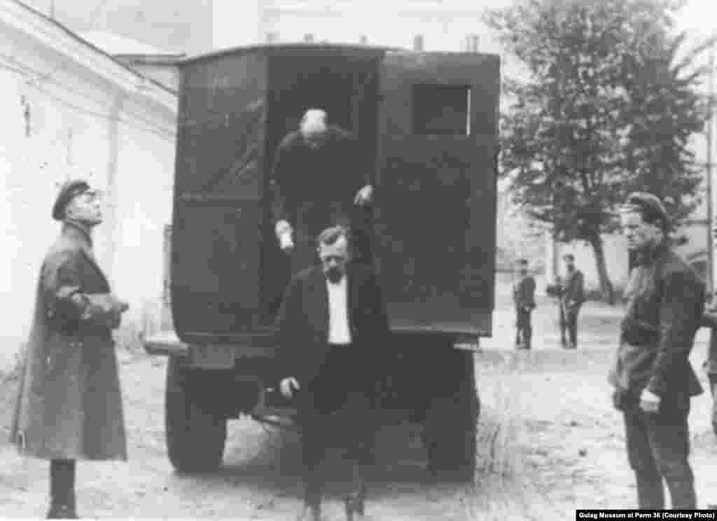 Two men exit a paddy wagon designed to look like a delivery truck. (undated)