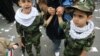 Children taking part in a rally marking the 30th anniversary of the Islamic Revolution in Tehran last year -- Iran's next generation of martyrs?