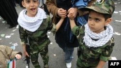 Children taking part in a rally marking the 30th anniversary of the Islamic Revolution in Tehran last year -- Iran's next generation of martyrs?