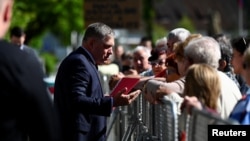 Slovak PM Robert Fico greets people in Handlova, Slovakia where he was shot on May 15.