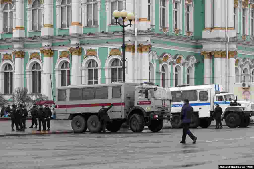 Police vehicles are seen parked on a street as Navalny supporters are expected to protest against his arrest in St. Petersburg on April 21.