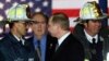 Russian President Vladimir Putin (center) with U.S. firefighters on November 15, 2001, as he visits the site of the September 11 terrorist attack that destroyed the twin towers of the World Trade Center in New York. 