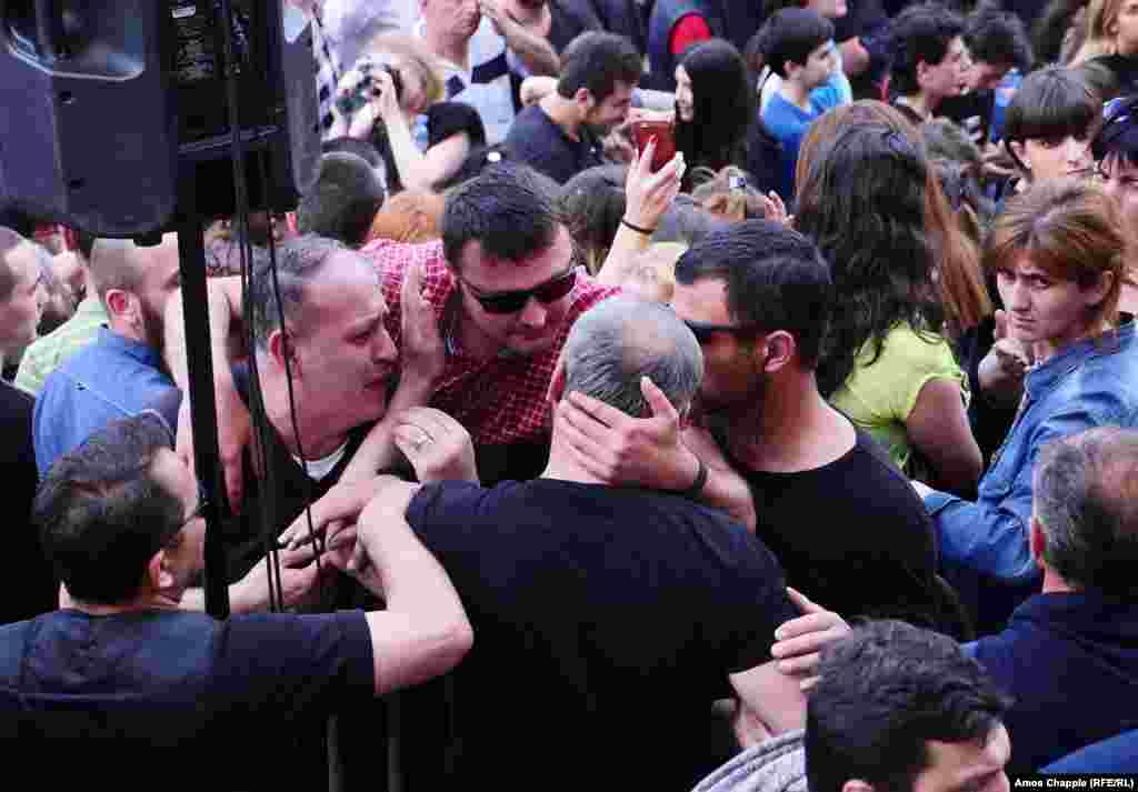 Protest leader Zaza Saralidze is comforted by fellow protesters.