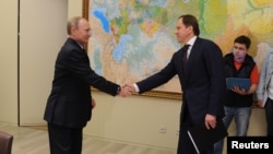 Russia's Minister for North Caucasus Affairs Lev Kuznetzov (right), seen here meeting with President Vladimir Putin, has said that the region's development plan will shift from alleviating social problems to focusing on attracting investment.