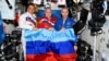 Russian cosmonauts onboard the International Space Station pose with a flag of separatist forces in Luhansk, Ukraine, on July 4.