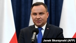 Polish President Andrzej Duda announces at a press conference on February 6 in Warsaw that he will sign into law a controversial Holocaust bill.