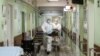 Medical workers move a patient on a trolley inside a hospital where patients suffering from COVID-19 are treated in Moscow.