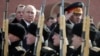 Russian President Vladimir Putin (left) and Defense Minister Sergei Shoigu watch a guard of honor passing by as they take part in a wreath-laying ceremony marking Defender of the Fatherland Day in Moscow. (file photo)