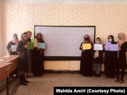 Activists and teachers protest inside a classroom in Kabul on October 20.