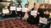 Women protest inside a private home on October 30. The protests are part of a campaign by women activists to press the Taliban for their right to work, get an education, and participate in public life.  