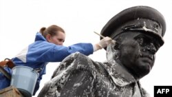 A municipal worker cleans a statue of Soviet World War II hero Marshal Georgy Zhukov in St. Petersburg in preparation for Victory Day festivities.