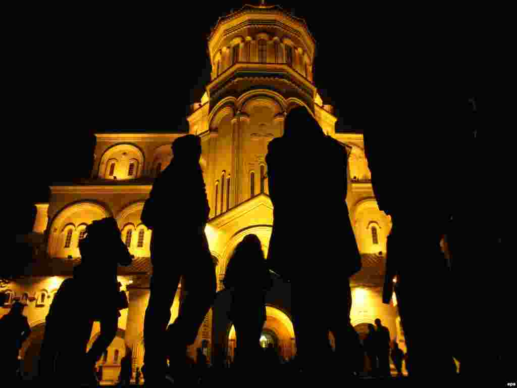 Georgian Orthodox believers walk to the Trinity Cathedral in Tbilisi for Christmas Mass. - Orthodox Christians celebrate Christmas on January 7, in keeping with the traditional Julian calendar, which sets the holiday 13 days later than the more widespread Gregorian calendar. Photos by AFP, epa, and RFE/RL