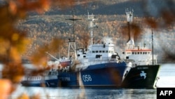 Greenpeace's "Arctic Sunrise"(right) is moored next to a Russian Coast Guard ship in the northern port of Murmansk.